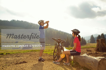 Man and woman resting with mountain bikes, Styria, Austria