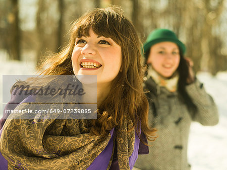 Two young women in snowy park