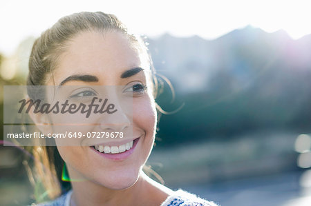 Portrait of young woman looking away, smiling