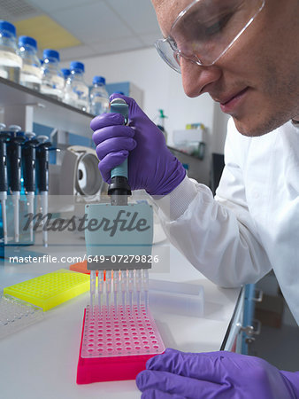 Male researcher using multi pipette in lab