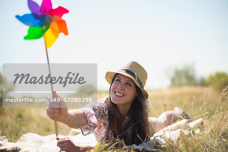 Woman lying in on front holding windmill
