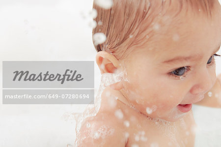 Baby splashing in bathtub