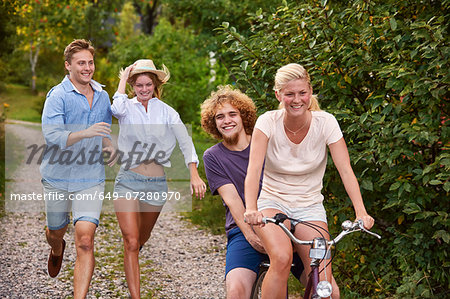 Two young couples chasing each other on bicycle, Gavle, Sweden