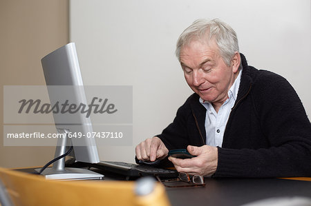 Senior man at home using personal computer