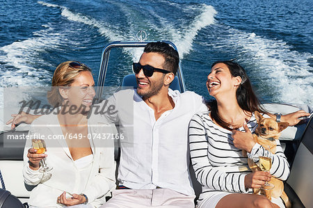 Young man on boat with arms around women, Gavle, Sweden