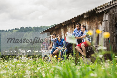 Group of friends chatting and reading map, Tirol, Austria