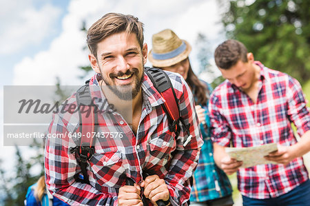 Portrait of young man wearing checked shirt, smiling