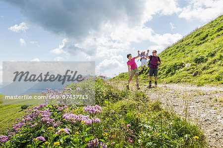 Parents and daughter having fun on walk, Tyrol, Austria Parents and daughter having fun on walk, Tyrol, Austria