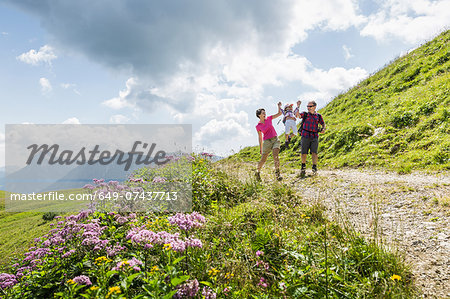 Parents and daughter having fun on walk, Tyrol, Austria