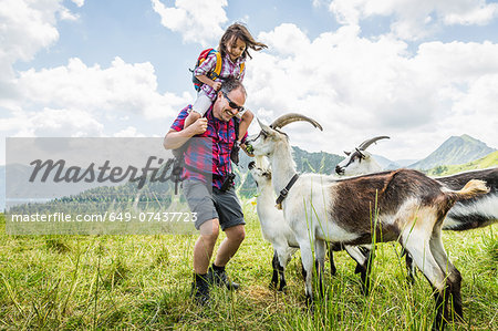Father and daughter with goats, Tyrol, Austria