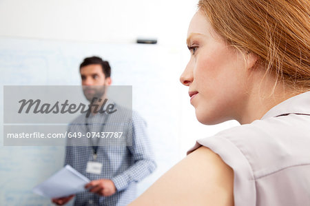 Young woman looking away in business meeting