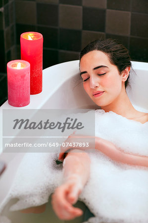 Young woman relaxing in bubble bath