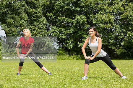Women warming up for exercise in park