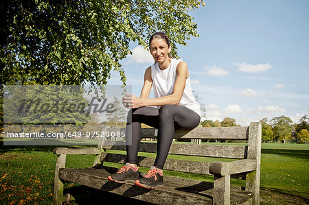 Woman sitting on park bench