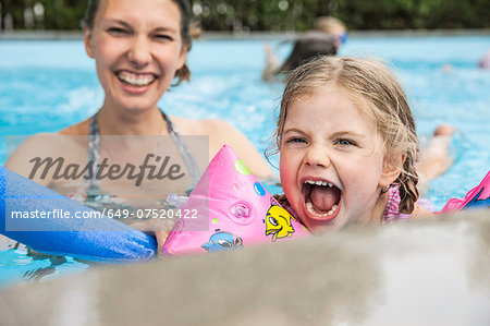 Mother and child having fun in pool
