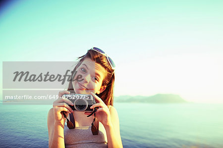 Portrait of girl holding camera on holiday, Kas, Turkey Portrait of girl holding camera on holiday, Kas, Turkey