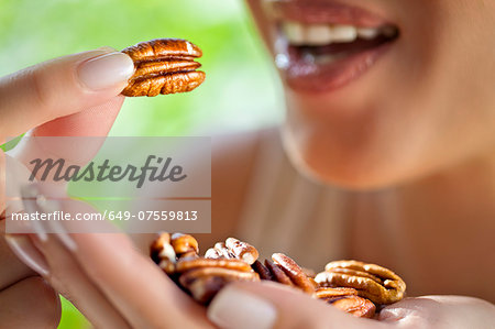 Woman with handful of pecans