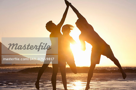 Friends jumping by seaside