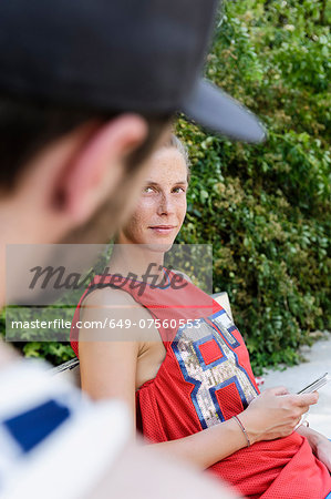 Two basketball players taking a break in park