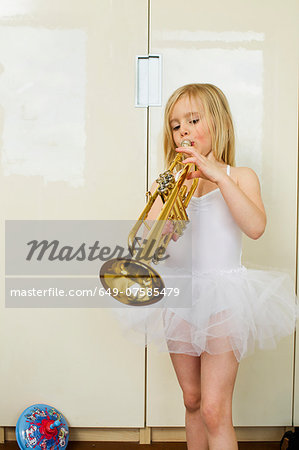 Portrait of young girl playing the trumpet