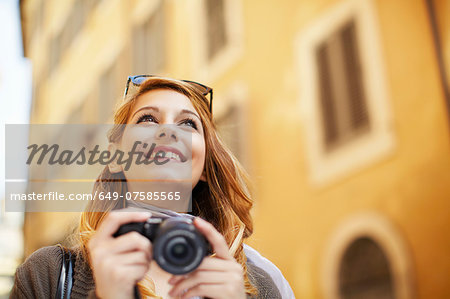 Young woman with digital camera, Rome, Italy