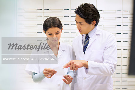 Pharmacists checking prescription in pharmacy