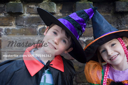 Portrait of boy and girl in halloween costumes