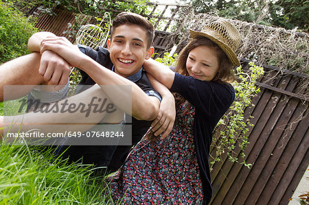 Teenage couple relaxing in garden
