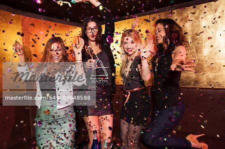 Four female friends partying in nightclub