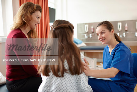 Nurse talking to patient and mother