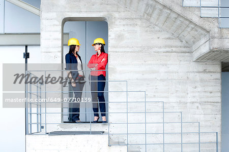 Businesswomen in safety helmet at balcony
