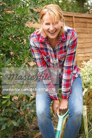 Portrait of mature woman having fun digging garden