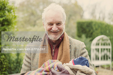 Grandfather cradling grandson, portrait