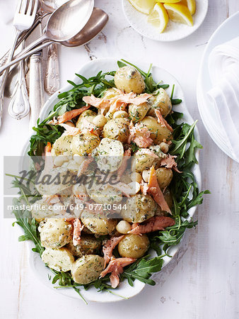 Still life of salad dish with fish and boiled new potatoes