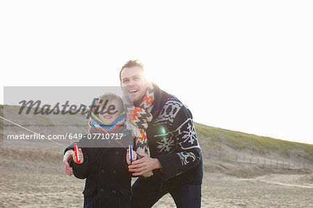 Mid adult man flying kite with son on beach, Bloemendaal aan Zee, Netherlands