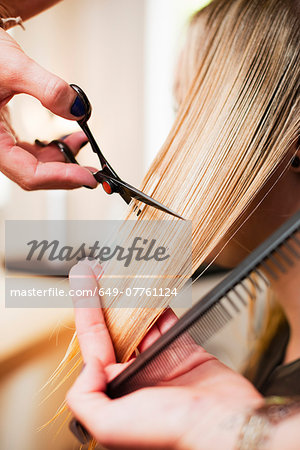 Woman having haircut in salon