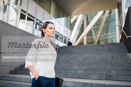 Young businesswoman carrying digital tablet, London, UK