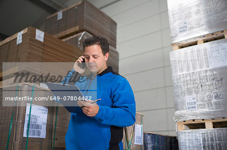 Factory worker checking pallets