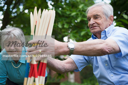 Grandfather and grandmother with giant pick up sticks