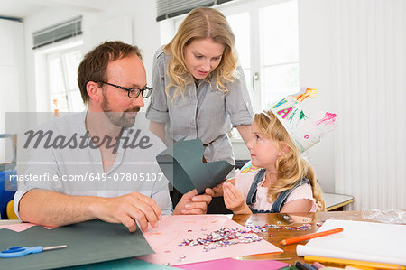 Family making paper crowns