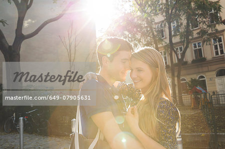 Young couple hugging on suburban street