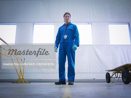 Portrait of aircraft engineer in aircraft maintenance factory