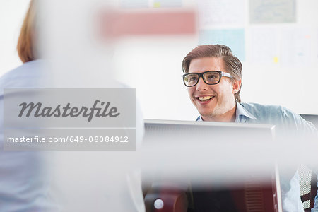 Businessman and woman chatting in office