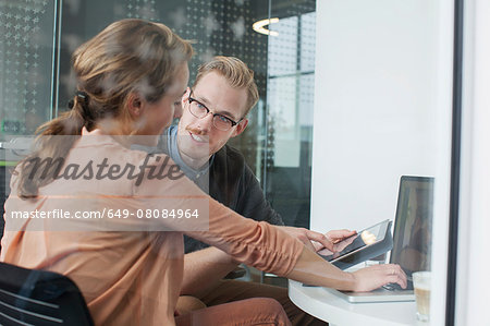 Woman and man chatting in office meeting