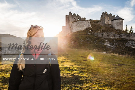 Young female hiker in front of Ehrenberg castle ruins, Reutte, Tyrol, Austria