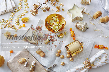 White and gold colored still life with confectionery and variety of objects