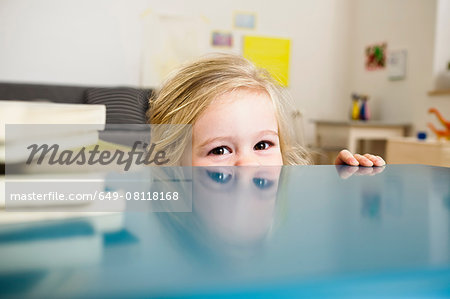Girl peeking over table