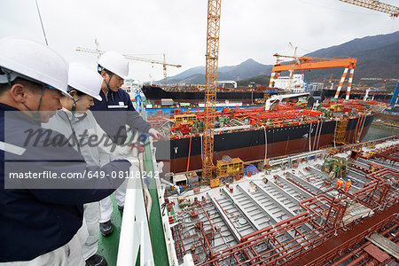 Workers looking over shipyard, GoSeong-gun, South Korea