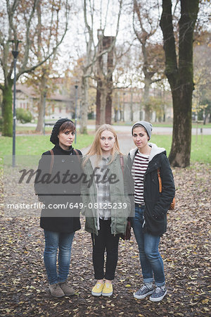 Three sisters posing in park