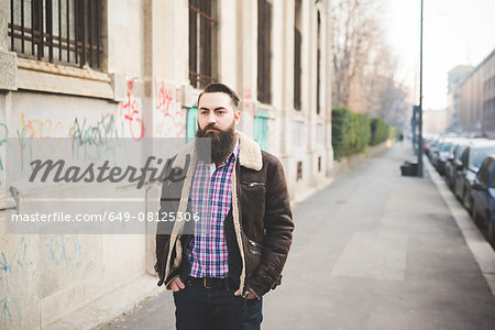 Young bearded man on pavement